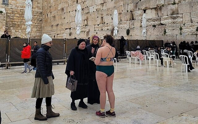 A woman strips down to a bathing suit at the Western Wall in an apparent protest on February 12, 2023. (Social media: Used in accordance with Clause 27a of the Copyright Law) A woman strips down to a bathing suit at the Western Wall in an apparent protest on February 12, 2023. (Social media: Used in accordance with Clause 27a of the Copyright Law)