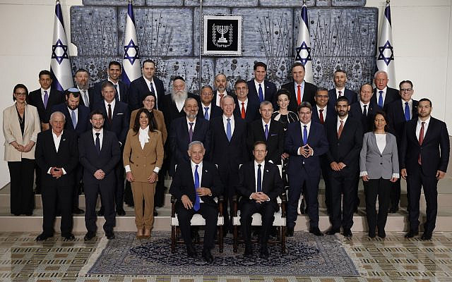 Members of the new Israeli government, headed by Prime Minister Benjamin Netanyahu, pose for a group photo at the president's residence in Jerusalem, on December 29, 2022. (Yonatan Sindel/Flash90)