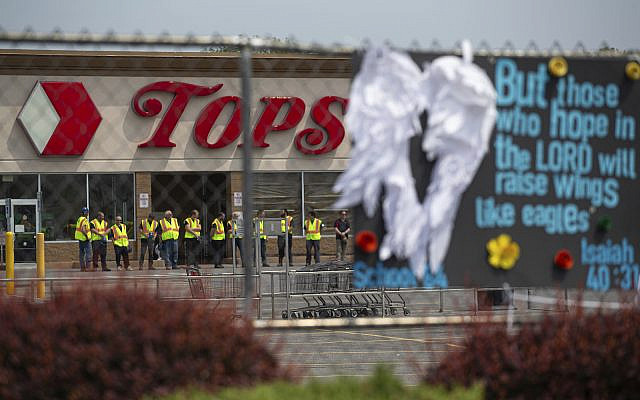 Investigators stand outside during a moment of silence for the victims of the Buffalo supermarket shooting outside the Tops Friendly Market, May 21, 2022, in Buffalo, N.Y. (AP Photo/Joshua Bessex) Investigators stand outside during a moment of silence for the victims of the Buffalo supermarket shooting outside the Tops Friendly Market, May 21, 2022, in Buffalo, N.Y. (AP Photo/Joshua Bessex)