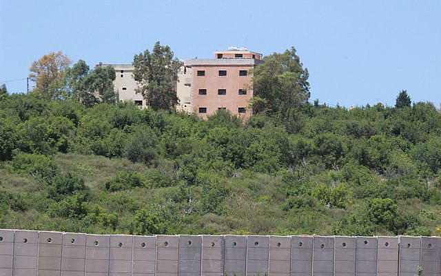 Hezbollah and Lebanese homes above the wall Israel is building along the border. Photo by Carrie Hart. Hezbollah and Lebanese homes above the wall Israel is building along the border. Photo by Carrie Hart.