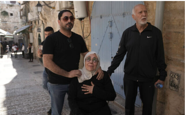 Noura Ghaith-Sub Laban, center, is comforted by family as she reacts to their eviction from their home. (Mahmoud Illean/AP)