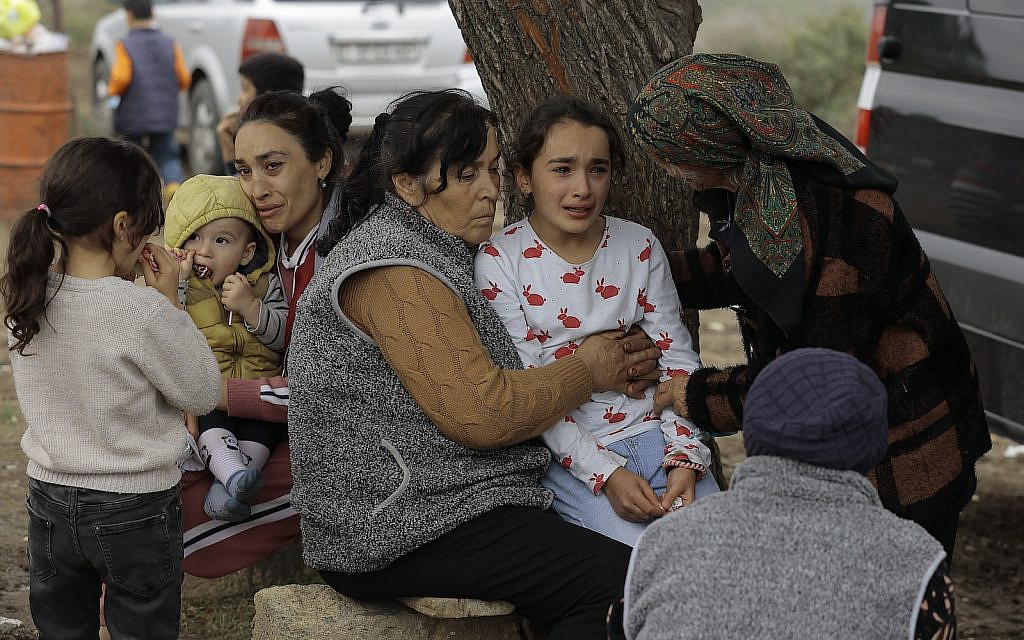 Ethnic Armenians from Nagorno-Karabakh comfort a young woman upon arriving to Kornidzor in Syunik region, Armenia, Tuesday, Sept. 26, 2023. Some 42,500 people, or about 35% of Nagorno-Karabakh's ethnic Armenian population, had left for neighboring Armenia as of Wednesday morning, according to Armenian authorities. Hours-long traffic jams were reported on Tuesday on the road linking Nagorno-Karabakh to Armenia. (AP Photo/Vasily Krestyaninov) Ethnic Armenians from Nagorno-Karabakh comfort a young woman upon arriving to Kornidzor in Syunik region, Armenia, Tuesday, Sept. 26, 2023. Some 42,500 people, or about 35% of Nagorno-Karabakh's ethnic Armenian population, had left for neighboring Armenia as of Wednesday morning, according to Armenian authorities. Hours-long traffic jams were reported on Tuesday on the road linking Nagorno-Karabakh to Armenia. (AP Photo/Vasily Krestyaninov)