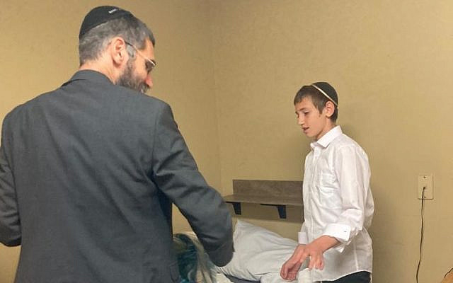 The author helps his son settle into the yeshiva dormitory. (courtesy)