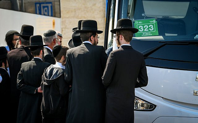 Illustrative: Ultra-Orthodox men board the bus to the Lag B'omer festival in Meron, in Jerusalem, on May 8, 2023. (Arie Leib Abrams/ Flash90) Illustrative: Ultra-Orthodox men board the bus to the Lag B'omer festival in Meron, in Jerusalem, on May 8, 2023. (Arie Leib Abrams/ Flash90)