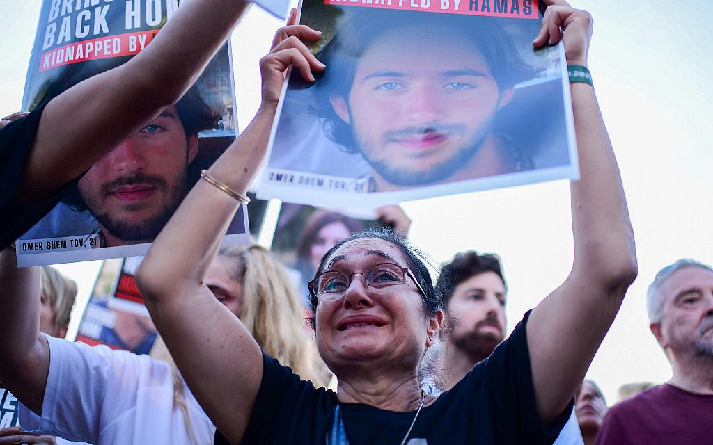 Families of Israelis held hostage by Hamas terrorists in Gaza and supporters hold up their photographs, at "Hostage Square,” outside the Art Museum of Tel Aviv, October 26, 2023. (Tomer Neuberg/Flash90)