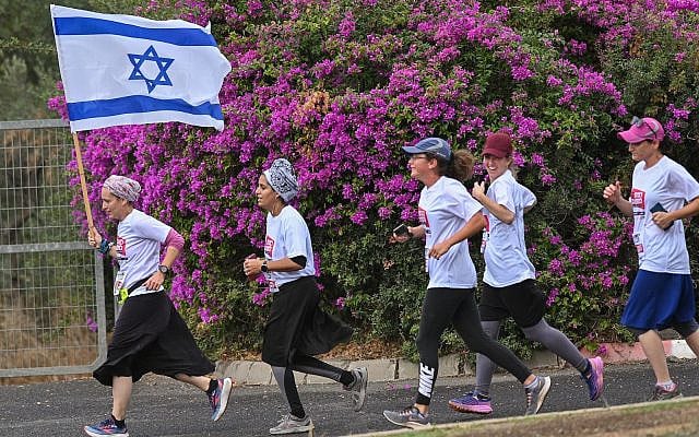 Women run for the release of Israelis held kidnapped by Hamas terrorists in Gaza, in Katsrin, on November 17, 2023. (Michael Giladi/Flash90) Women run for the release of Israelis held kidnapped by Hamas terrorists in Gaza, in Katsrin, on November 17, 2023. (Michael Giladi/Flash90)