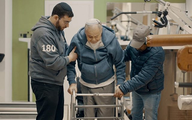 Yad Sarah Physiotherapy Volunteers helping a Man Walk