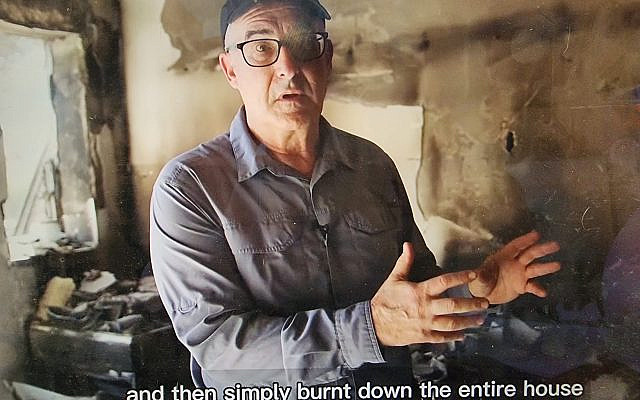 Aren Maeir, at the Be'eri home of a family murdered on October 7, 2023. (courtesy)