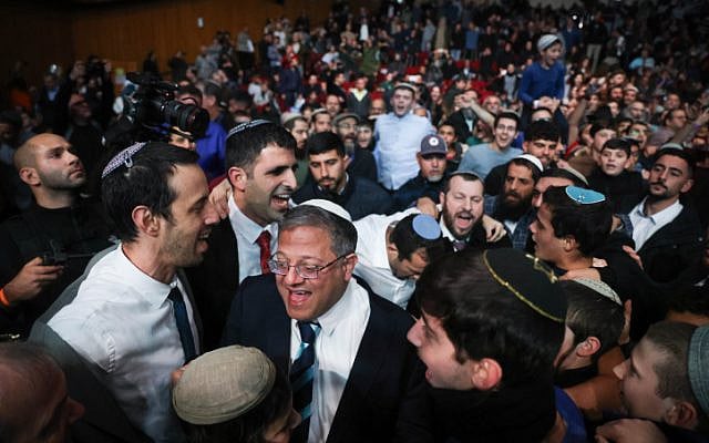 Government ministers and coalition MKs dance during a conference promoting the revival of Jewish settlements in Gaza, at the International Convention Center in Jerusalem, January 28, 2024. National Security Minister Itamar Ben Gvir is at front, center. (Chaim Goldberg/Flash90)
