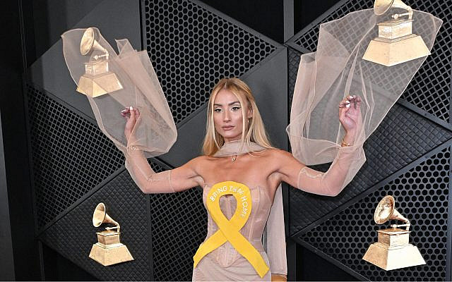 Montana Tucker at the 66th Annual Grammy Awards wearing a dress emblazon  with a yellow ribbon to call attention to the Israeli hostages in Gaza. (Photo by Robyn Beck/AFP via Getty Images)