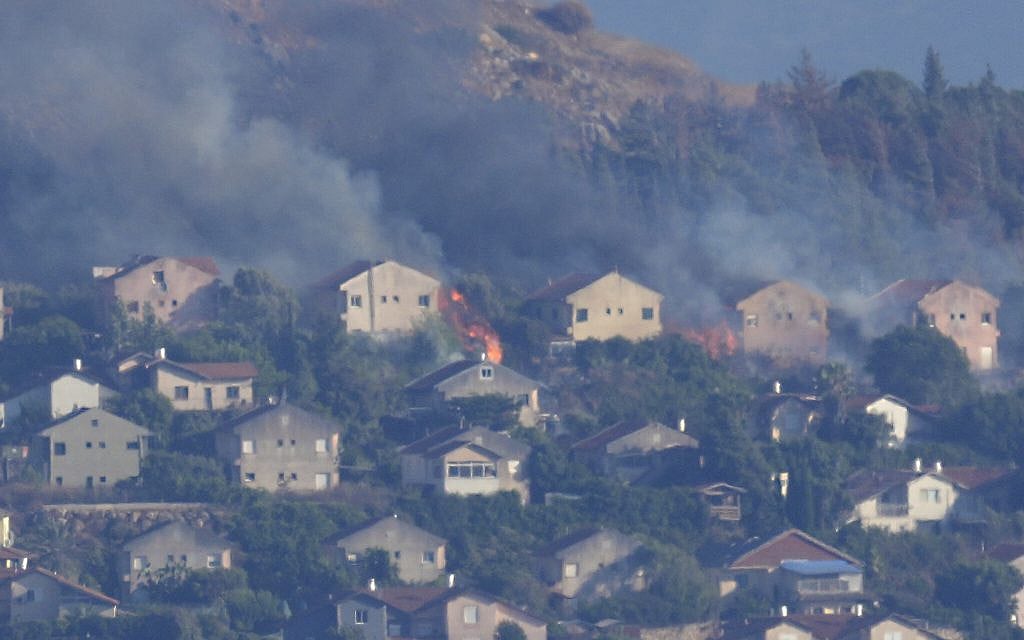 Fires and smoke rise at houses in the northern Israeli border town of Metula, hit by Hezbollah shelling, as seen from the Lebanese town of Marjayoun, Lebanon, June 22, 2024. (AP Photo/Hussein Malla, File)