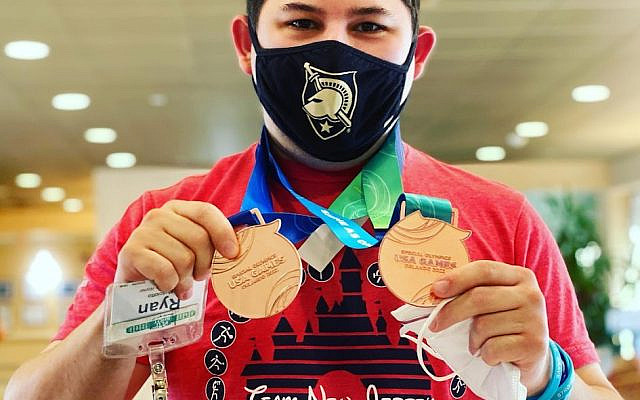 Ryan Musciotto with his bowling medals.