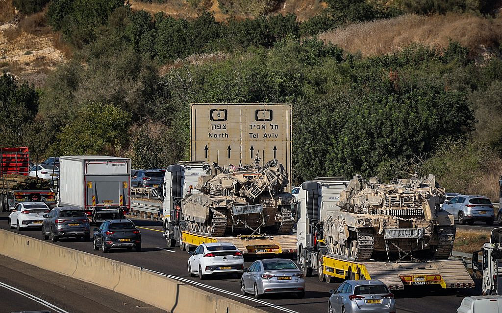 A military truck rides on top of another truck, in traffic, on the way to the northern border with Lebanon, September 18, 2024. (Yossi Aloni/ Flash90)