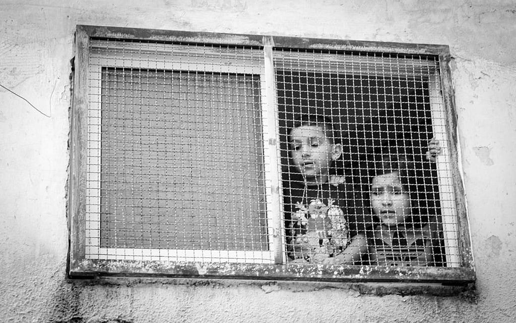 Palestinian children peer at our group in the West Bank in 2017.