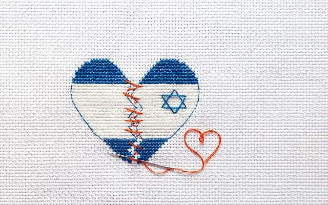 Embroider the broken heart of the colors of the flag of Israel sewed with red threads. Heart surgery.