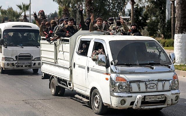 Security forces loyal to the interim Syrian government ride in the back of a vehicle moving along a road in Syria’s western city of Latakia on March 9, 2025. (Omar Haj Kadour/AFP) Security forces loyal to the interim Syrian government ride in the back of a vehicle moving along a road in Syria’s western city of Latakia on March 9, 2025. (Omar Haj Kadour/AFP)