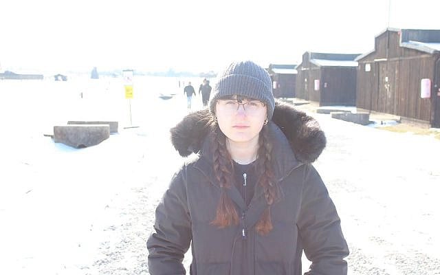 Miriam Frankel stands before the Majdanek concentration camp barracks. Photo by Max Segal.