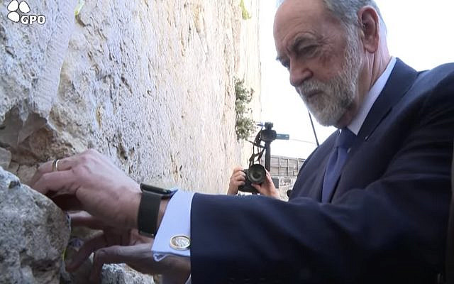 As his first official act as Ambassador to Israel, Mike Huckabee places a prayer in the Western Wall on behalf of President Trump (Screenshot from Israel Government Press Office live broadcast)