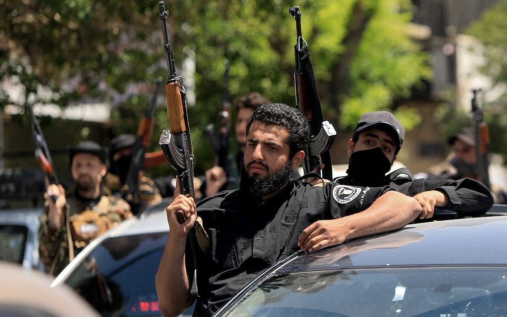Members of Syria's security forces stand guard next to their vehicles in the capital Damascus on April 29, 2025, following overnight sectarian clashes that left nine people including six Druze fighters dead. (Bakr ALKASEM / AFP)