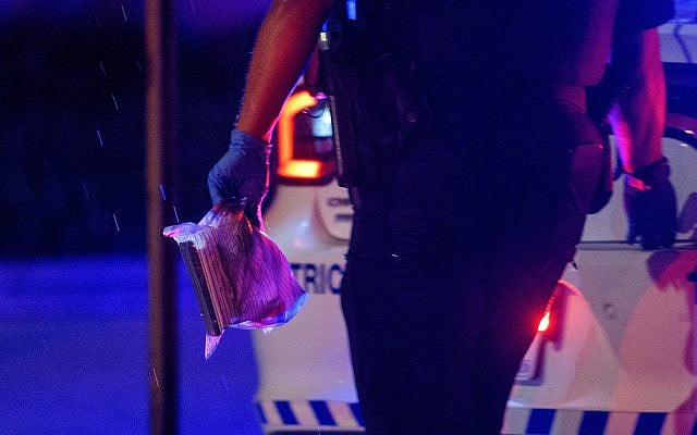 A Washington DC Metro police officer carries an evidence bag to his car after two staff members of the Israeli Embassy in Washington were shot and killed outside the Capital Jewish Museum, May 22, 2025, in Washington. (AP Photo/Rod Lamkey, Jr.)