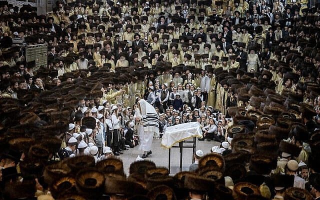 Worshippers from the Toldos Aharon Hasidic group carry Torah scrolls as they dance during Simhat Torah celebrations in Jerusalem’s Mea Shearim neighborhood, October 24, 2024. (Chaim Goldberg/ Flash90)