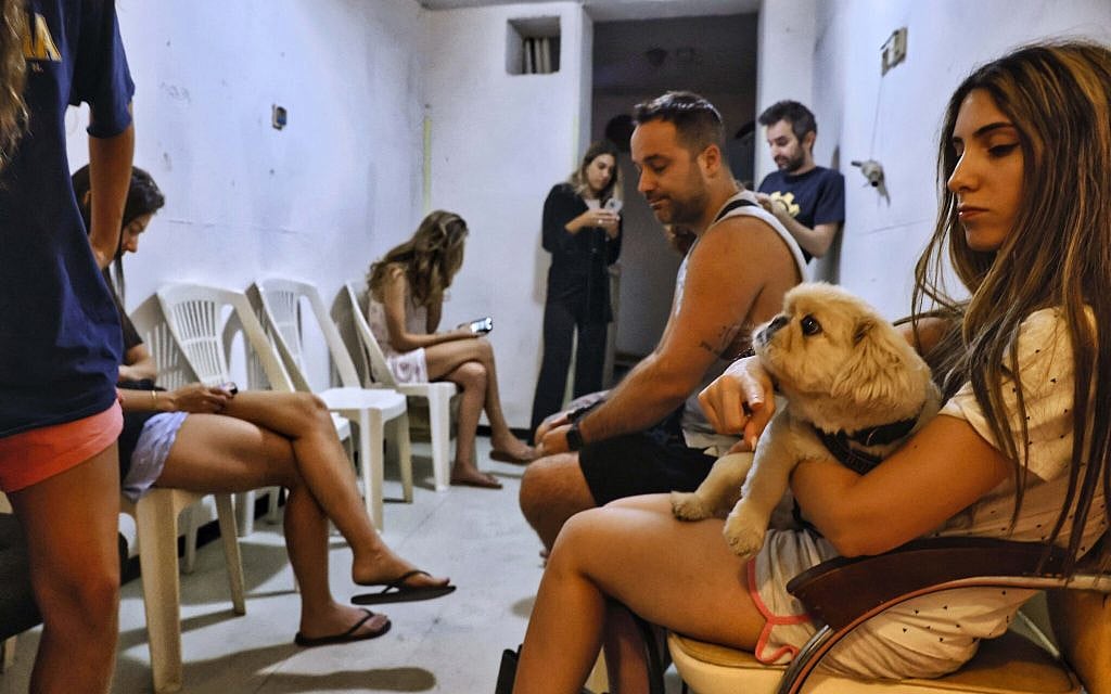 Israelis take cover inside a bomb shelter as a siren alert is sounded in Tel Aviv, October 23, 2024. (Yehoshua Yosef/Flash90)