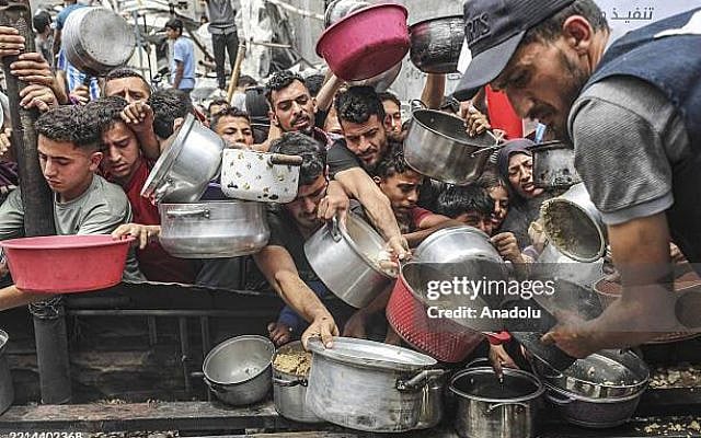 GAZA , GAZA - MAY 14: Charitable organizations distribute hot meals to Palestinians in the Jabalia refugee camp in the northern Gaza Strip, Gaza on May 14, 2025. As Israel's relentless and devastating attacks on the Gaza Strip continue, Israeli policies have exacerbated the already severe humanitarian crisis in the region. (Photo by Mahmoud ssa/Anadolu via Getty Images)