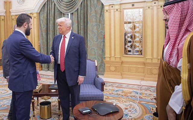 Syria's interim President Ahmad al-Sharaa, left, shakes hands with President Donald Trump, center, in Riyadh, Saudi Arabia, on May 14, 2025. At right is Saudi Crown Prince Mohammed bin Salman. (Bandar Aljaloud/Saudi Royal Palace via AP)