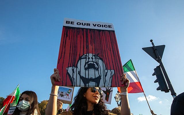 A woman holds a sign reading “Be Our Voice” during a solidarity protest with Iranian demonstrators, held at the Victory Column in Berlin, Germany, on October 22, 2022. Photo: Michael Kuenne