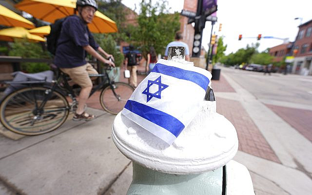 Cyclist passes by the flag of Israel, taped on a hydrant on the east end of the Pearl Street Mall, after a Sunday attack near the courthouse Monday, June 2, 2025, in Boulder, Colo. (AP Photo/David Zalubowski) Cyclist passes by the flag of Israel, taped on a hydrant on the east end of the Pearl Street Mall, after a Sunday attack near the courthouse Monday, June 2, 2025, in Boulder, Colo. (AP Photo/David Zalubowski)