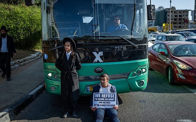 Ultra-Orthodox Jews clash with police during a protest against the drafting of ultra-Orthodox Jews to the IDF, on road 4 near Bnei Brak, June 5, 2025. (Erik Marmor/Flash90)