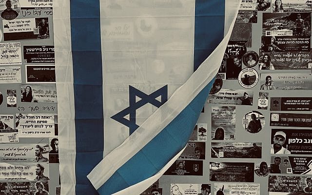 Israeli flag and memorial stickers for hostages and those killed on October 7, 2023, at the Nova Festival site in Re’im, Israel. (Photo: Daniel Balva)