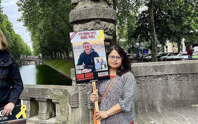 Holding up the poster of Daniel Perez (22), who fell on October 7, 2023, while fighting Hamas terrorists. His body is still held hostage in Gaza.