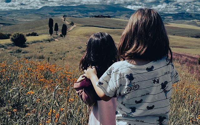 Photo by Manuele De Luca from Pexels: https://www.pexels.com/photo/children-embracing-in-picturesque-tuscany-landscape-32547495/