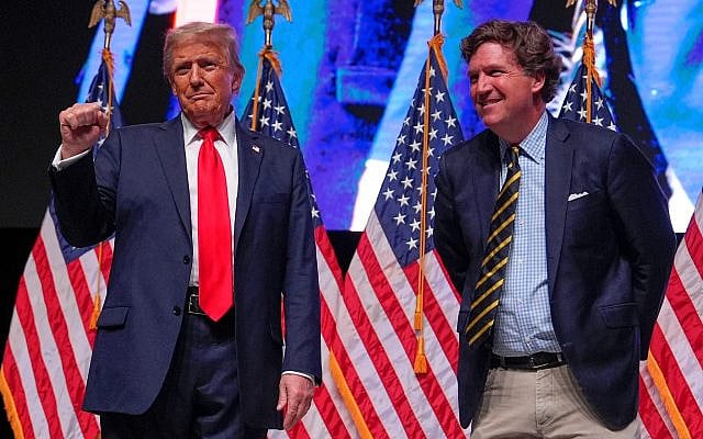 Then-Republican nominee running for a second nonconsecutive term, Donald Trump speaks with Tucker Carlson during a Tucker Carlson Live Tour show at Desert Diamond Arena, October 31, 2024, in Glendale, Arizona. (AP Photo/ Julia Demaree Nikhinson)