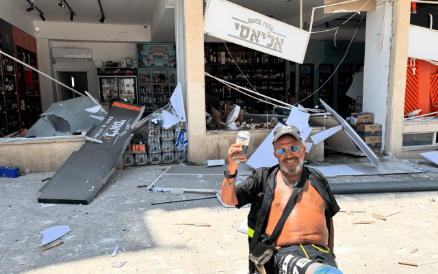 A liquor store employee enjoying a beer while his store is destroyed. L'chaim!