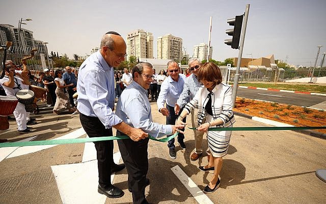 Dr. Zipora Schorr (in front, at right) — a representative of The Haron Dahan Foundation — cuts the ribbon at the recent dedication ceremony for the new Aharon and Rachel Dahan Gate at Bar-Ilan University. Also pictured are Rabbi Mitchell Wohlberg (in center), President of The Haron Dahan Foundation, and Bar-Ilan University President Prof. Arie Zaban (at left). Photo by Shlomi Mizrahi.