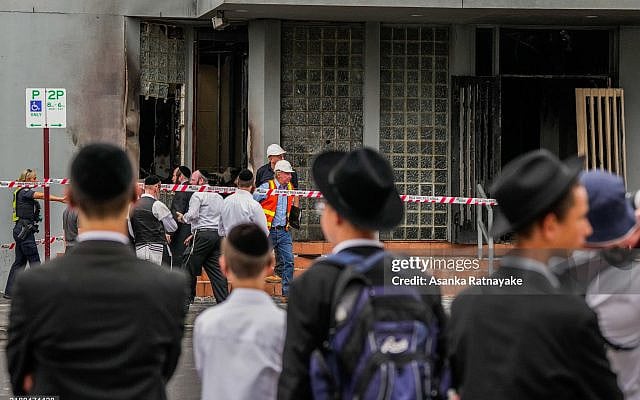MELBOURNE, AUSTRALIA - DECEMBER 06: Members of the local Jewish community look at the damage of the arson attack at the  Adass Israel Synagogue on December 06, 2024 in Melbourne, Australia. An arson attack on the Adass Israel Synagogue in Melbourne forced congregants to flee as flames engulfed the building early on Friday morning. Prime Minister Anthony Albanese condemned the incident as an antisemitic act, emphasizing that such violence at a place of worship is unacceptable in Australia. (Photo by Asanka Ratnayake/Getty Images)