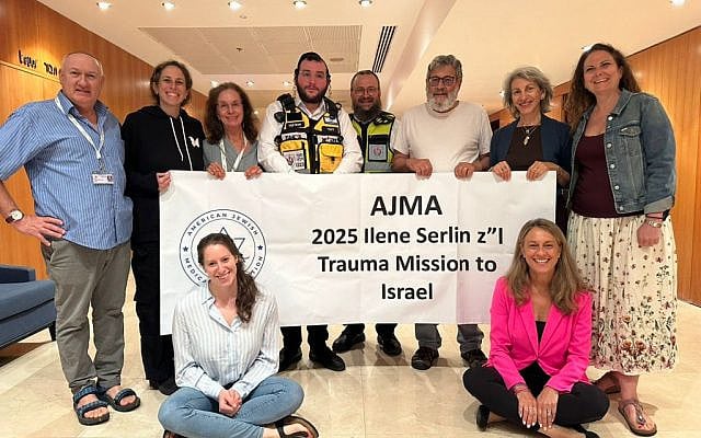 ZAKA spokesperson, Yisrael Chasid (left), and ZAKA volunteer, Simcha Yaffa (right), with American and Canadian mental health professionals, trauma experts, and students on the AJMA Israel Trauma Mission.