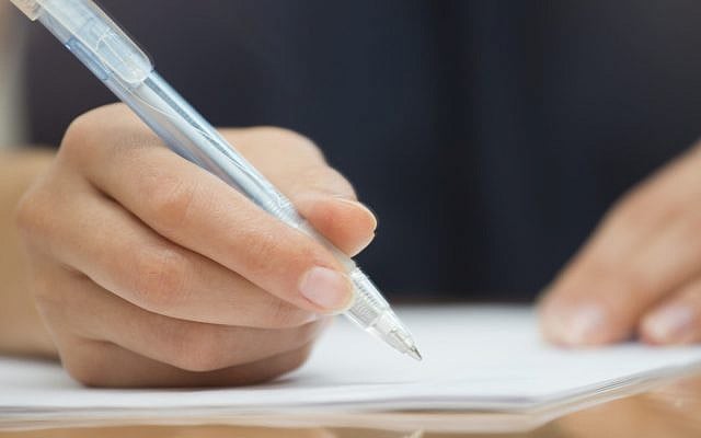 Woman writing with pen