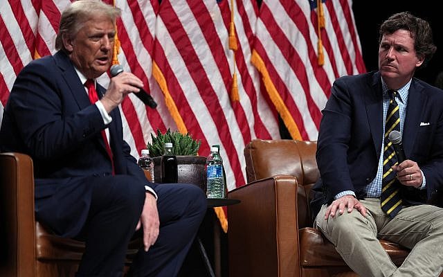 Republican presidential nominee former President Donald Trump speaks with Tucker Carlson during a Tucker Carlson Live Tour show at Desert Diamond Arena, Thursday, Oct. 31, 2024, in Glendale, Ariz. (AP Photo/Julia Demaree Nikhinson)