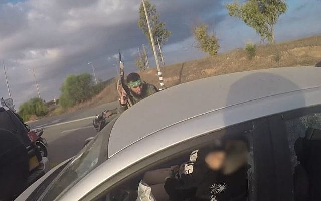 Screenshot of Hamas bodycam footage as terrorists approach an Israeli vehicle during the terror organization's October 7, 2023, attack in southern Israel, released by the IDF and Government Press Office. (Screenshot)