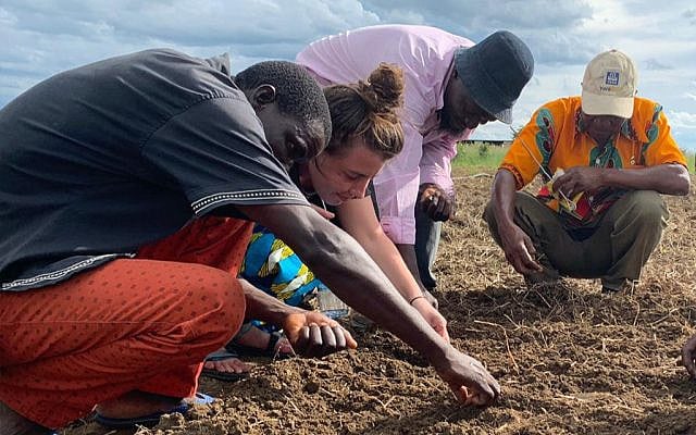 A member of Tevel b'Tzedek works with residents of a village in Zambia (Courtesy) A member of Tevel b'Tzedek works with residents of a village in Zambia (Courtesy)