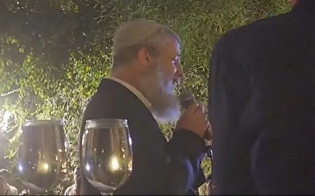 Rabbi Tamir Granot, officiating at the wedding of the former fiancée of his son, who was killed in war, and the husband Rabbi Granot had encouraged her to find. (Screenshot, via Facebook)