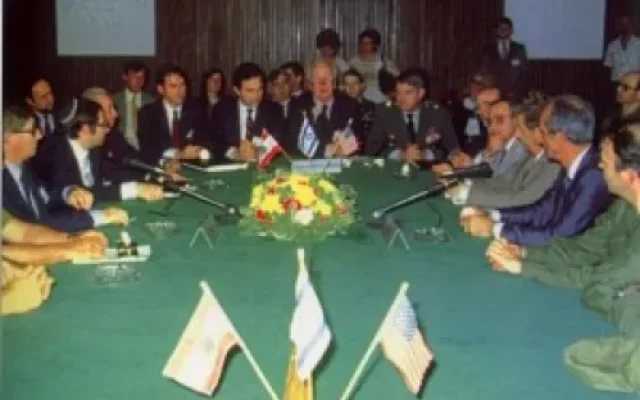 The signing of the Israel-Lebanon peace treaty in Kiryat Shmona, May 17, 1983. Pictured are the Israeli delegation (left), the Lebanese delegation (right), and the U.S. delegation led by Morris Draper (center). From left to right on the Israeli side: Maj.-Gen. Menahem Einan, Maj.-Gen. Avraham Tamir, David Kimche, and Elyakim Rubinstein. // Photo: Harnik Nati, Government Press Office