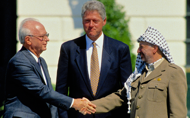 Washington, DC, Sept. 13, 1993 — Israeli Prime Minister Yitzhak Rabin and PLO Chairman Yasser Arafat shake hands after signing the Peace Accords. (Shutterstock)