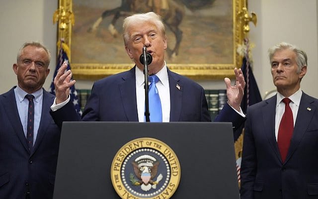 President Donald Trump speaks in the Roosevelt Room of the White House, Monday, Sept. 22, 2025, in Washington, as Health and Human Services Secretary Robert F. Kennedy Jr., left, and Centers for Medicare & Medicaid Services administrator Dr. Mehmet Oz listen. (AP Photo/Mark Schiefelbein)