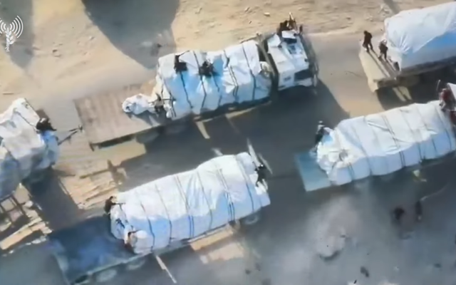 Palestinian gunmen atop trucks carrying humanitarian aid in Rafah, September 2024. (Screenshot/IDF).