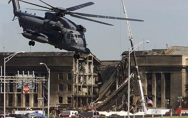 A military helicopter takes off after dropping off personnel at the Pentagon, Wednesday, Sept. 12, 2001, as work continued at the Pentagon after a terrorist crashed a hijacked airliner into the building Tuesday. (AP Photo/Ron Edmonds)