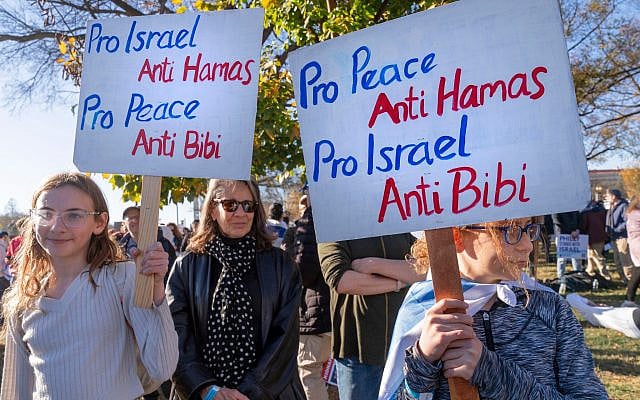 Noa Friedan, 13, left, and her sister Eila Friedan, 11, of Philadelphia, hold signs saying, 'Pro Israel, Anti Hamas; Pro Peace, Anti Bibi' as they attend the March for Israel rally, November 14, 2023, at the National Mall in Washington. (AP Photo/Jacquelyn Martin)